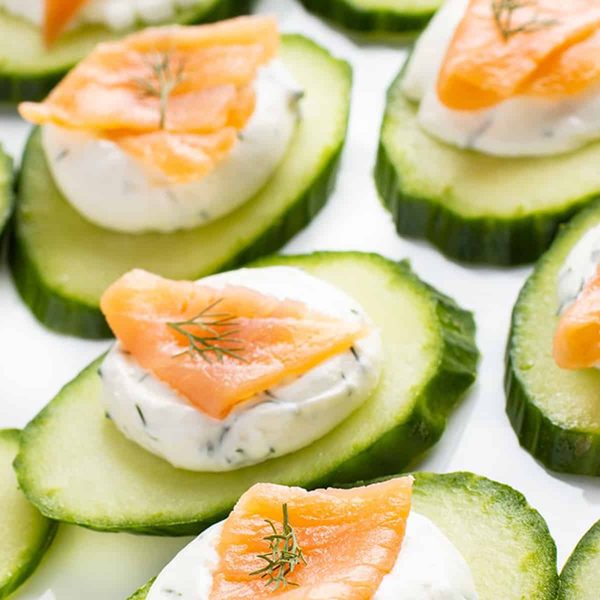 Some cucumbers with cream cheese on top.