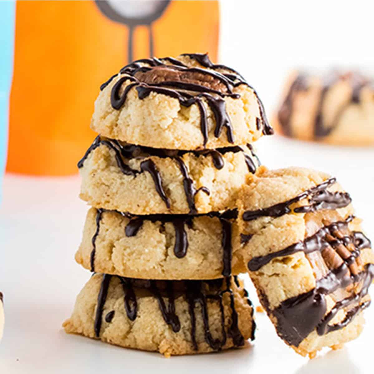 A stack of cookies with chocolate drizzled over them.