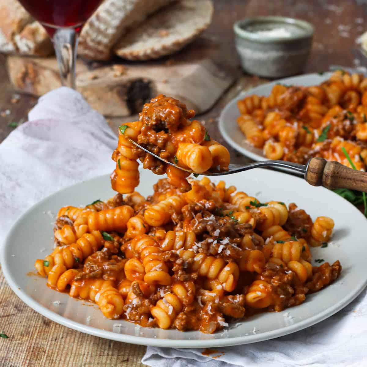 A plate of pasta with red sauce.