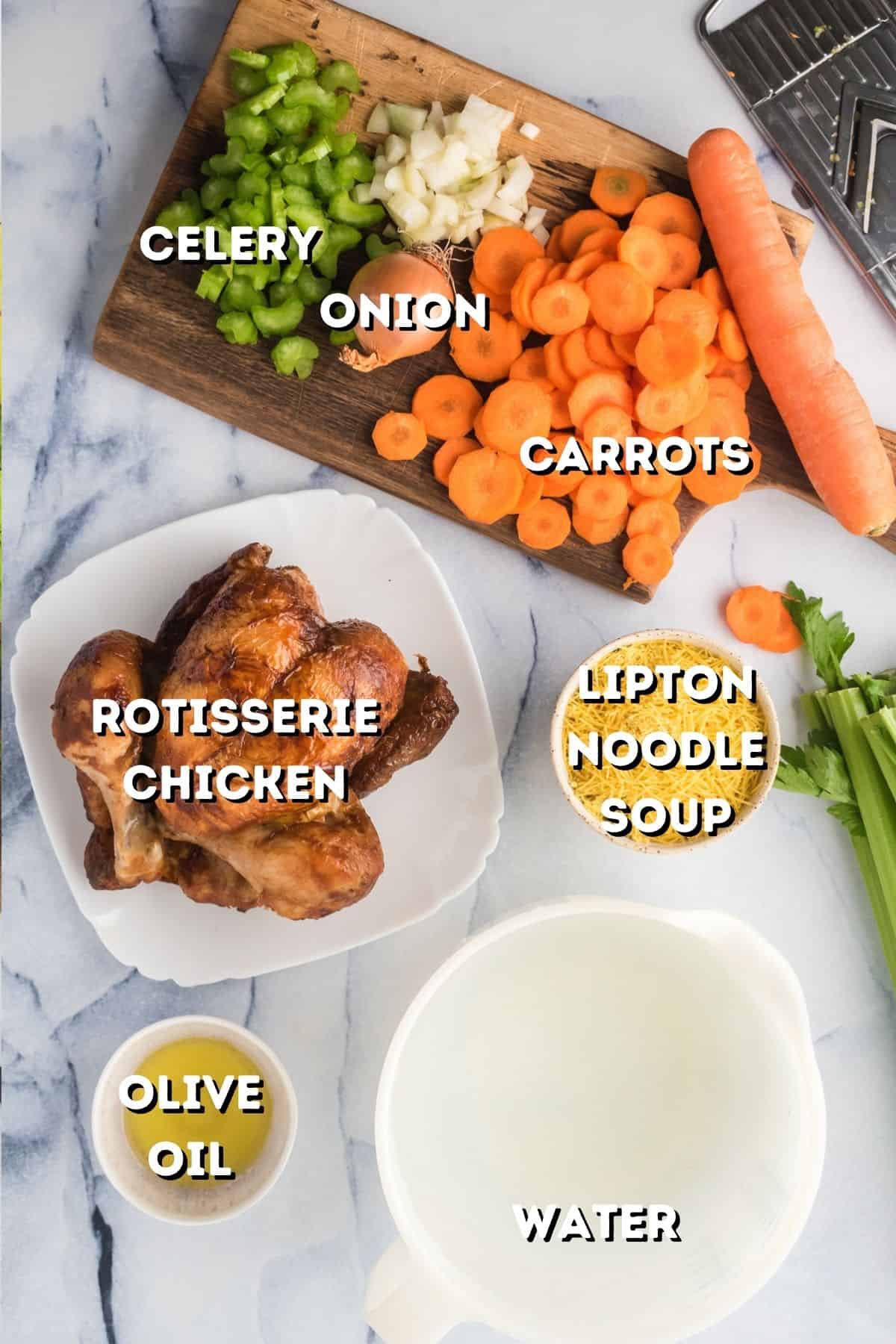 Vegetables on a cutting board and a rotisserie chicken with some Lipton noodle soup mix.