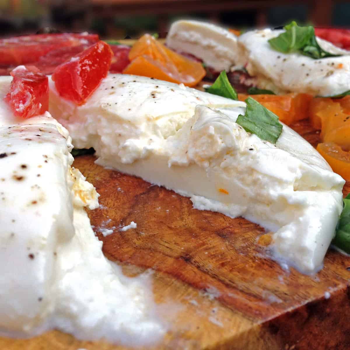 burrata cheese on a cutting board.