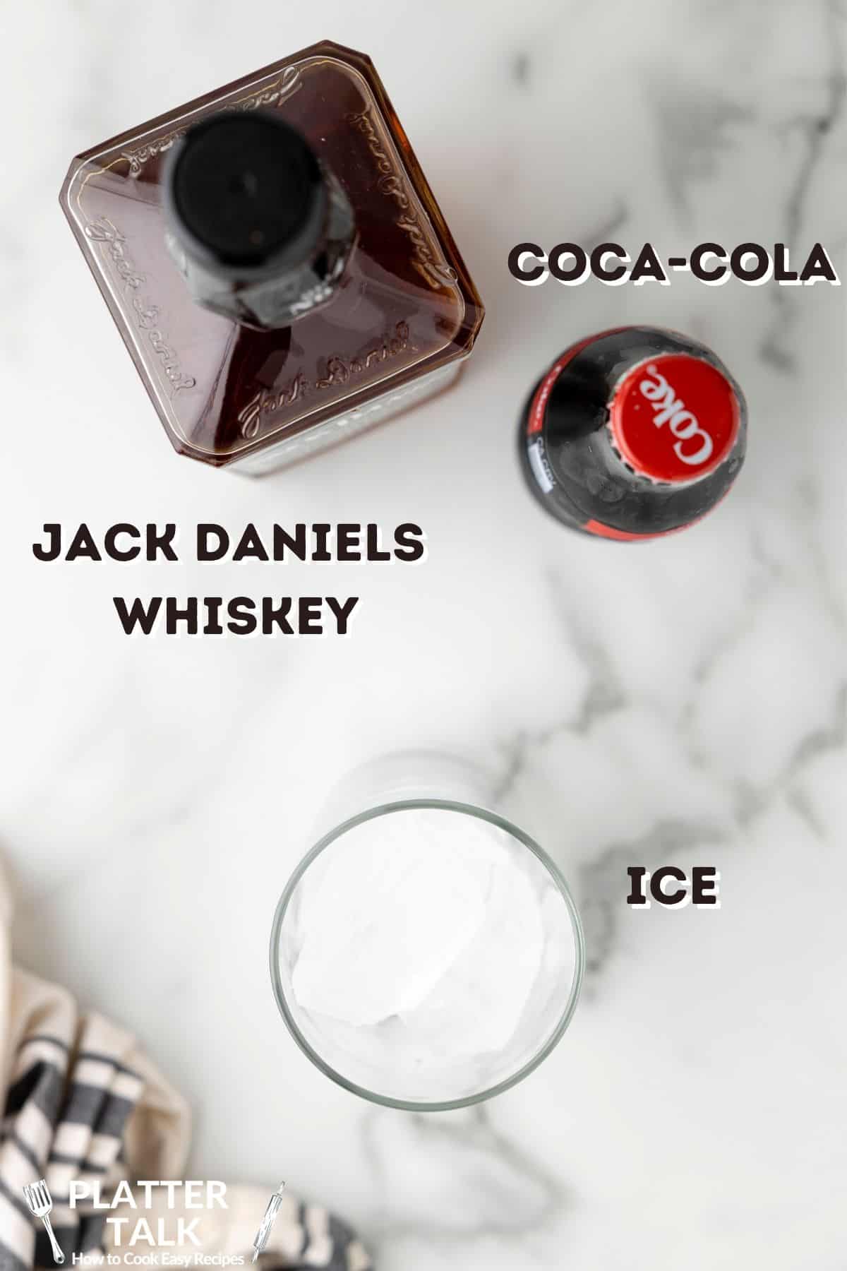 A bottle of Jack Daniels Whiskey and a bottle of coke with glass of ice.