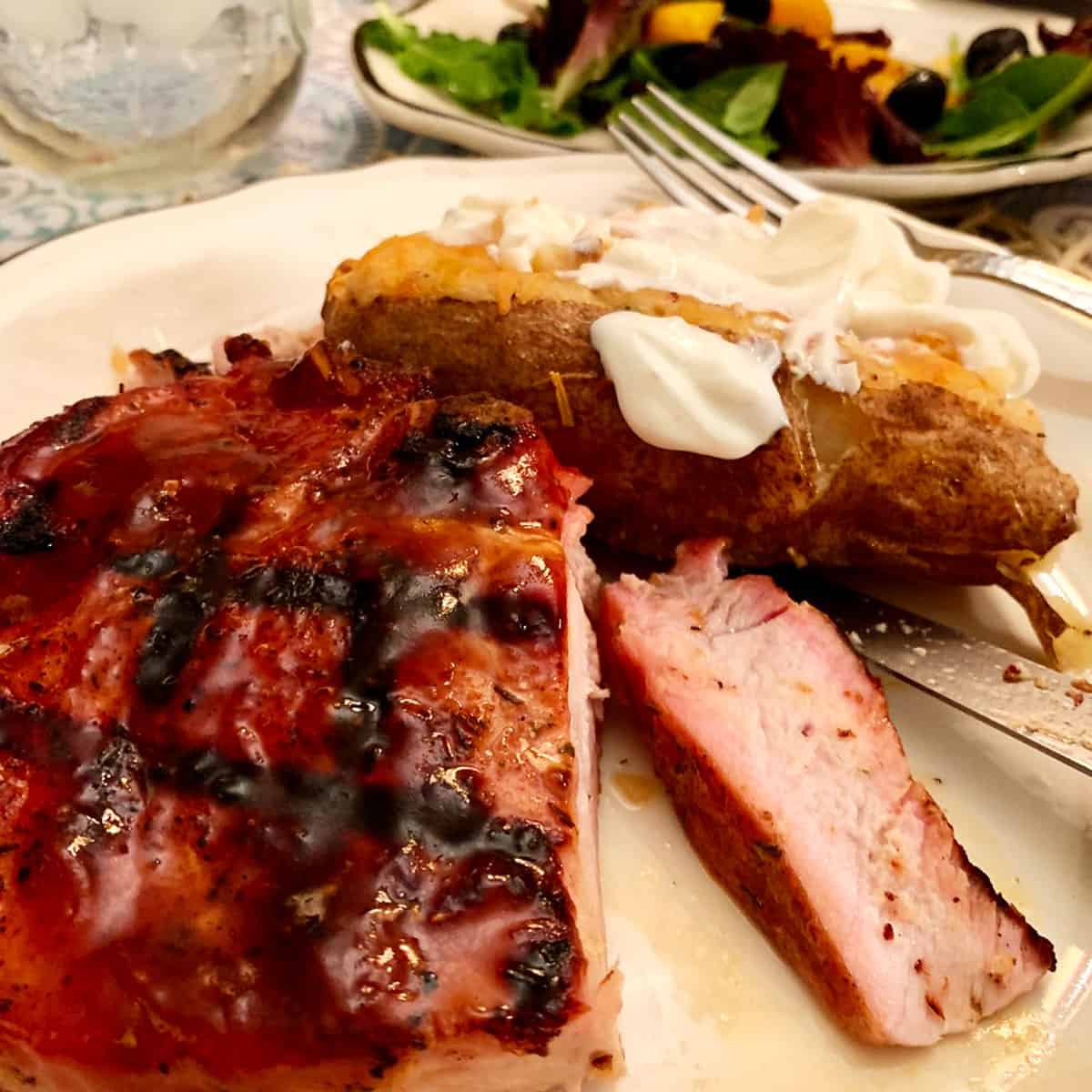 A plate of food with a baked potato