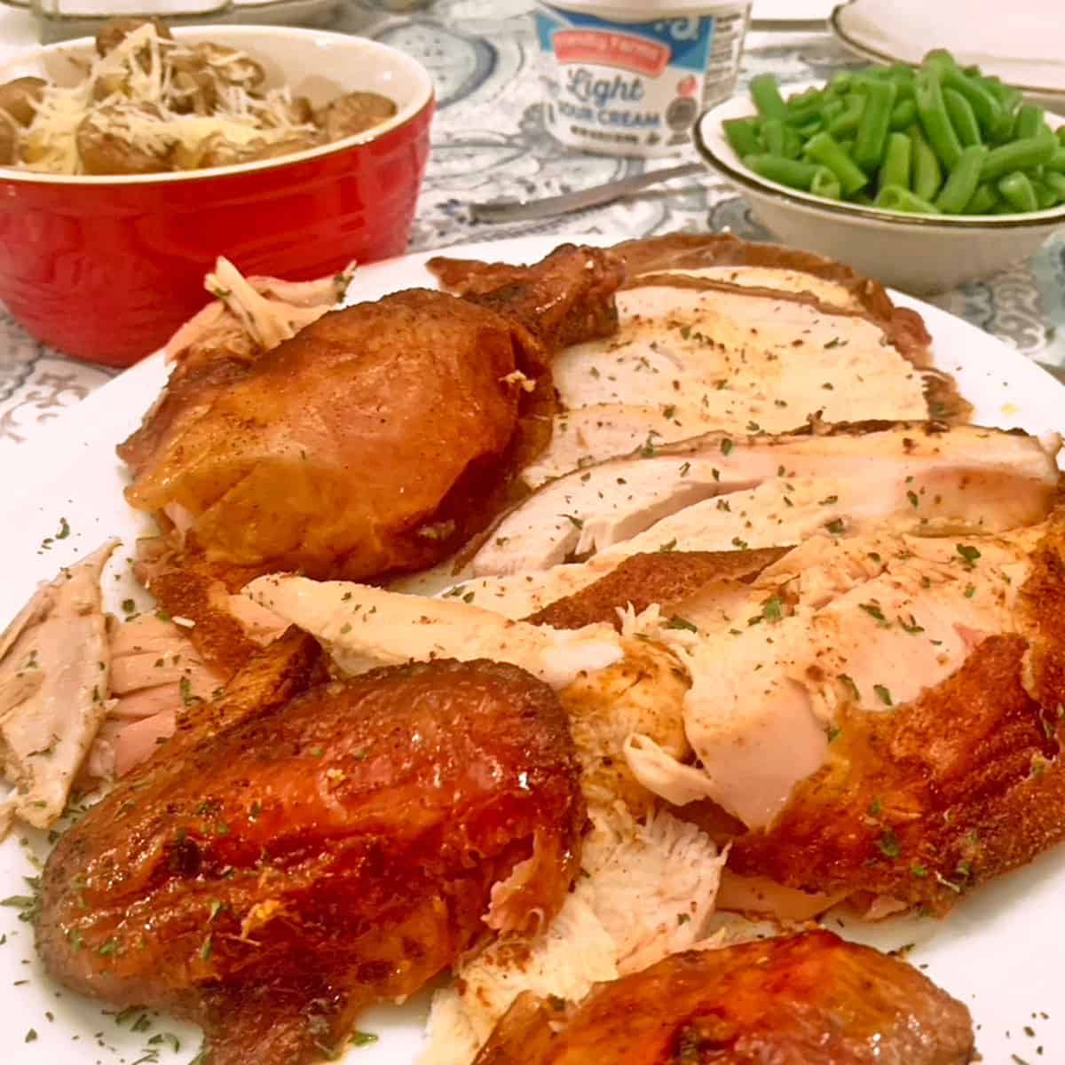 A platter of smoked chicken and side dishes.