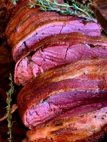 A smoked beef tenderloin, cooked medium rare and sliced.