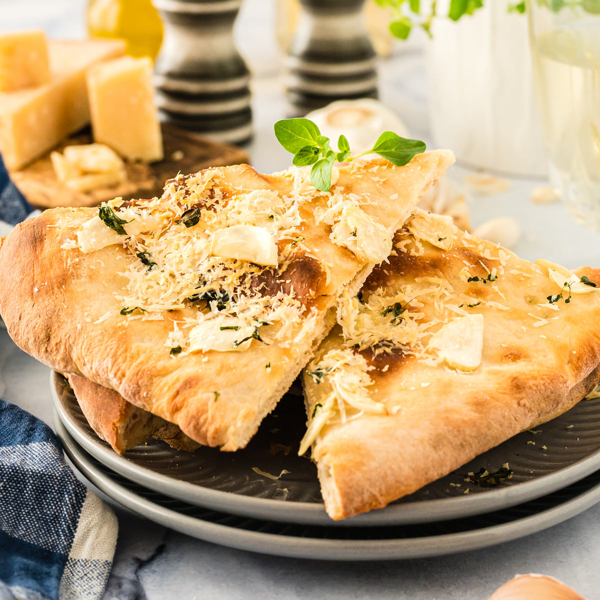 Two slices of homemade garlic pizza on a plate.