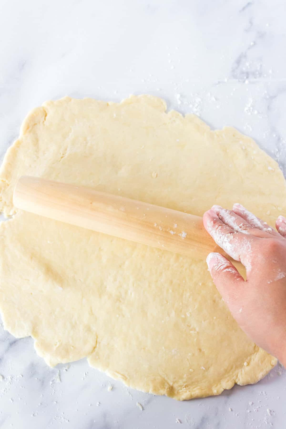 Rolling out a homemade pie dough.