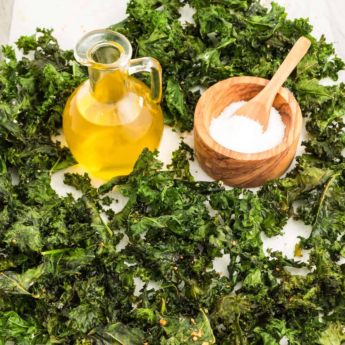 A plate of kale chips with olive oil and sea salt.