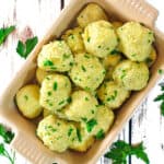 Overhead view of some potato dumplings in a baking dish.