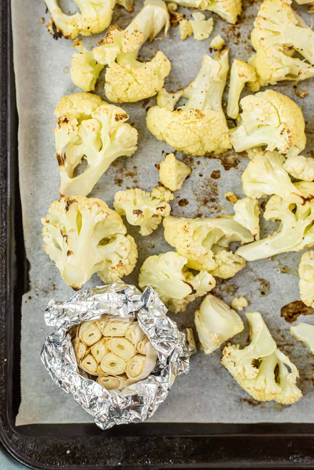 A sheet pan of roasted cauliflower and garlic.