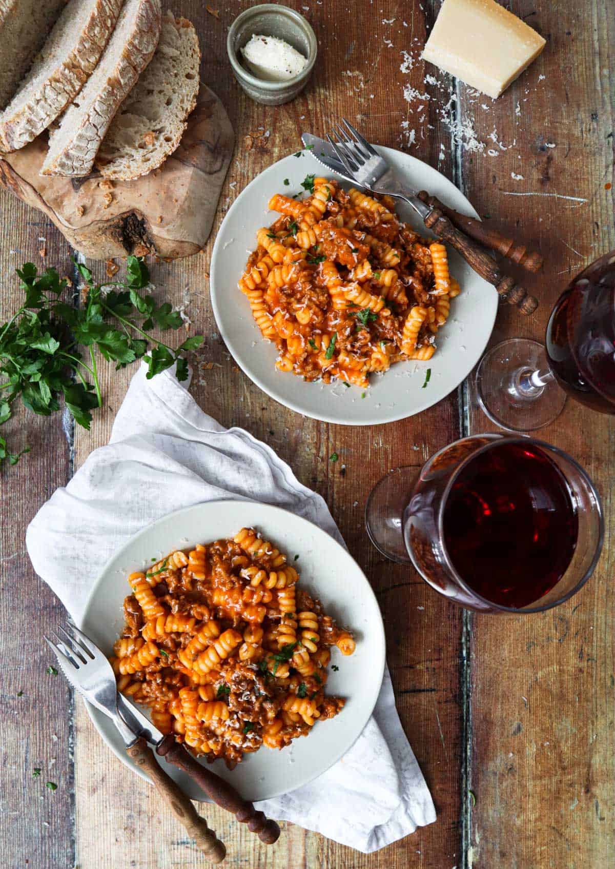 A table of food with bread and pasta.