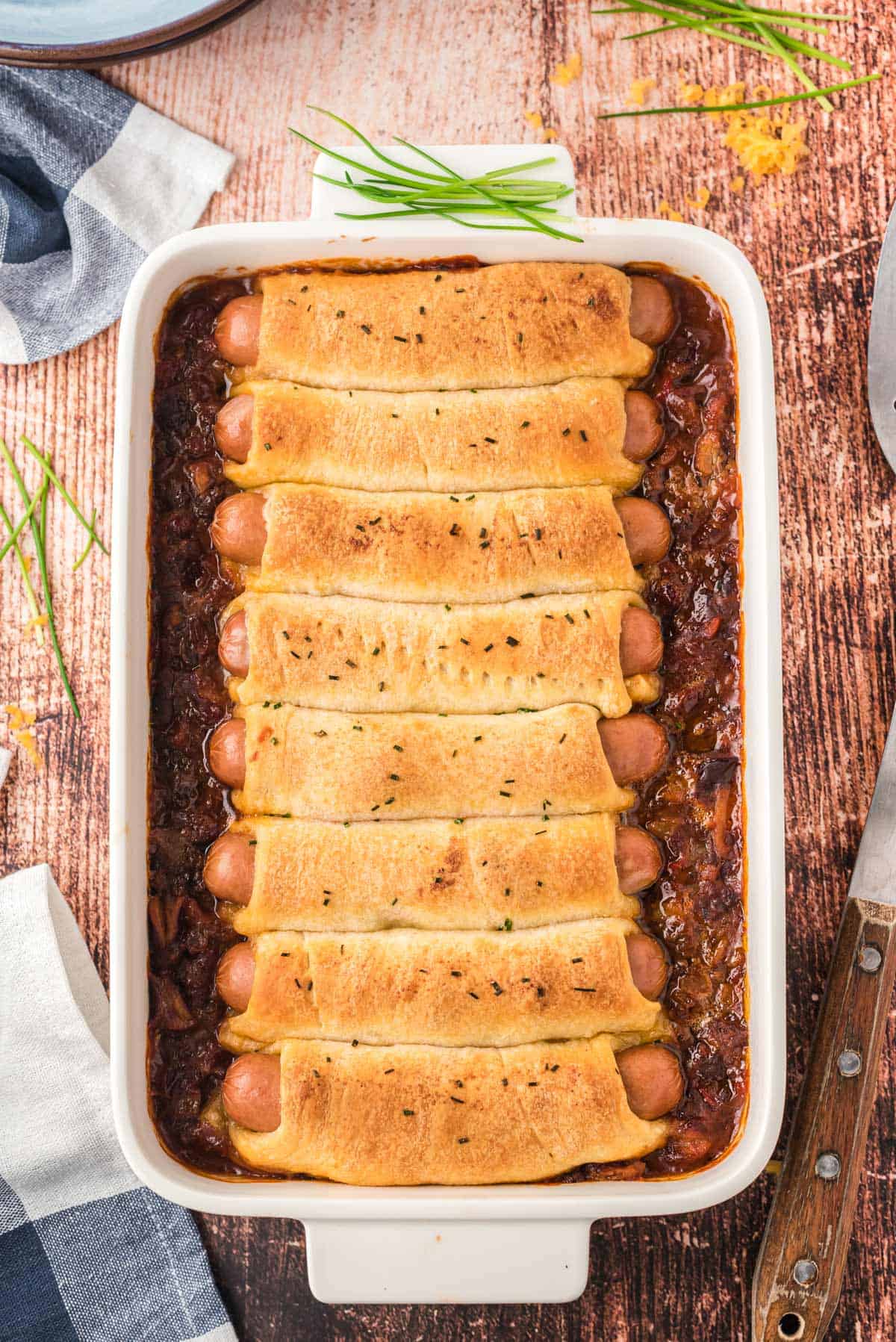 A dish of baked chili cheese dog casserole.