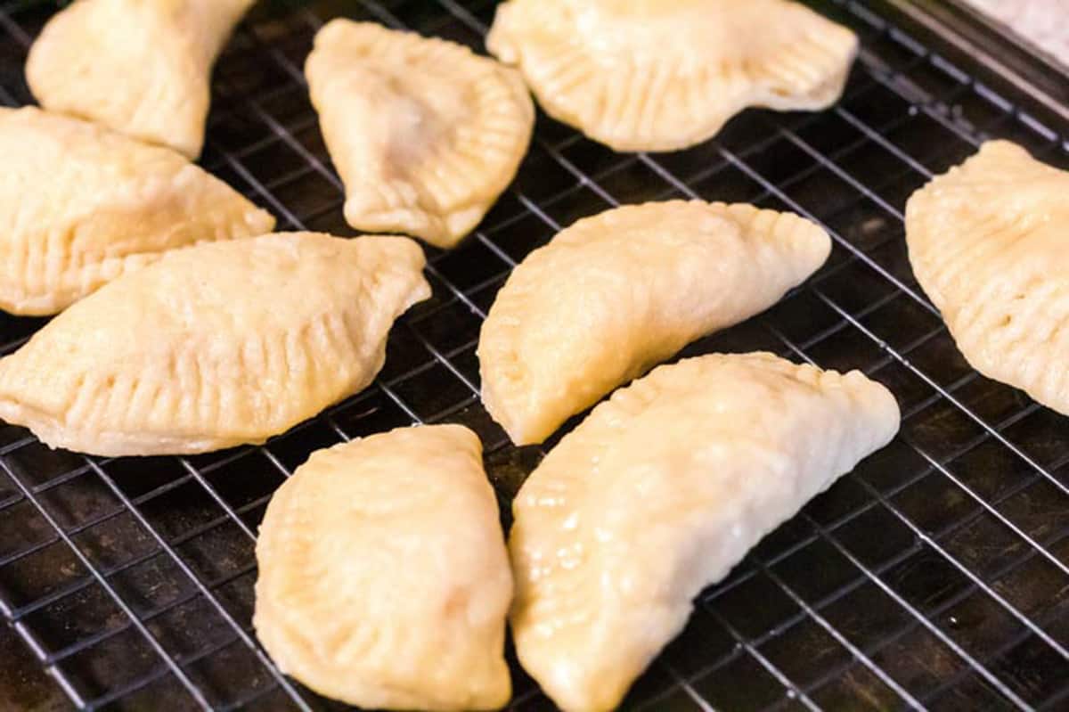 A bunch of pierogi on a cooling rack