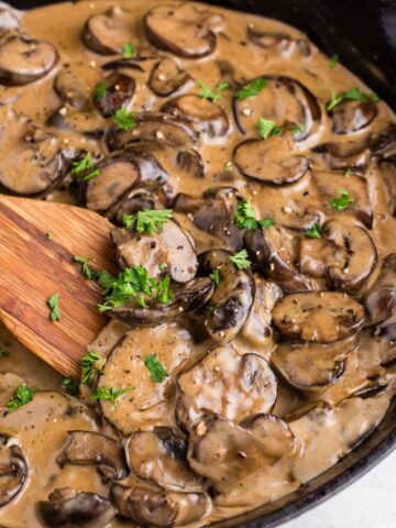 A skillet of creamy mushroom sauce.