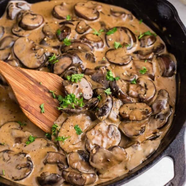 A skillet of creamy mushroom sauce.