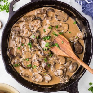 A skillet of creamy mushroom sauce.