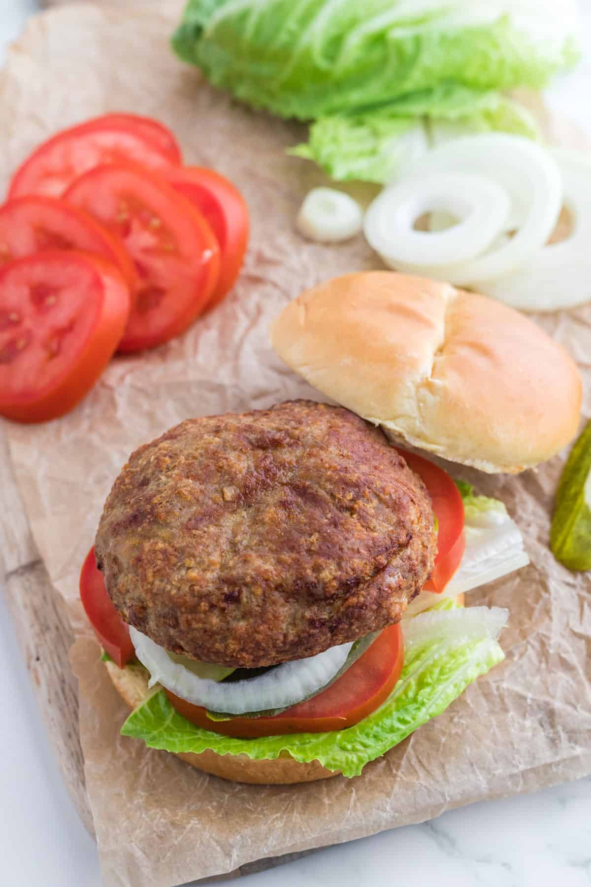 A burger with some toppings.