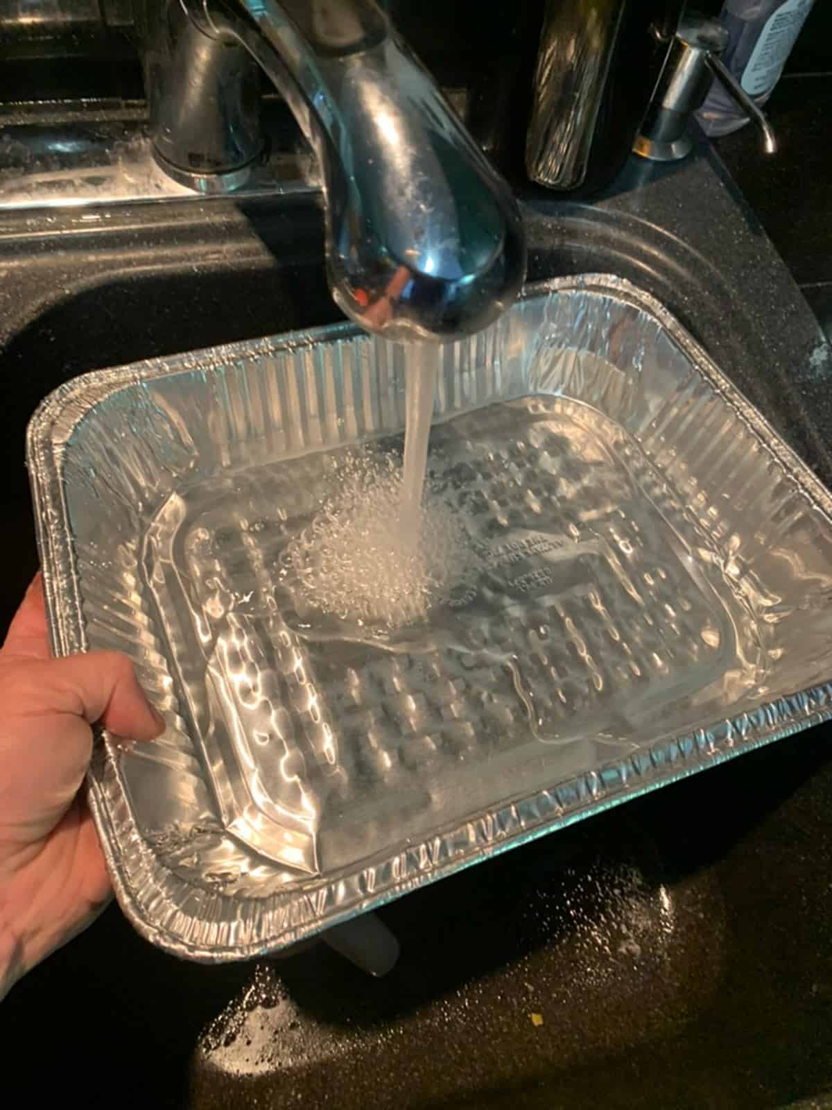 Adding water to a water pan.