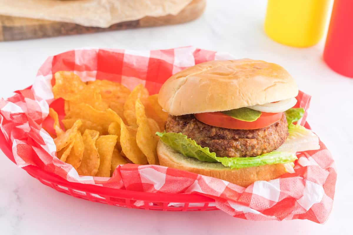 A burger and chips in a basket.