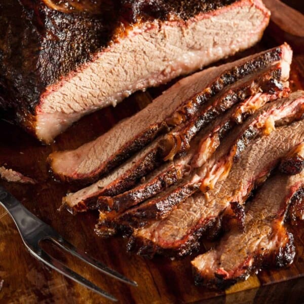 A smoked brisket sliced on a cutting board.