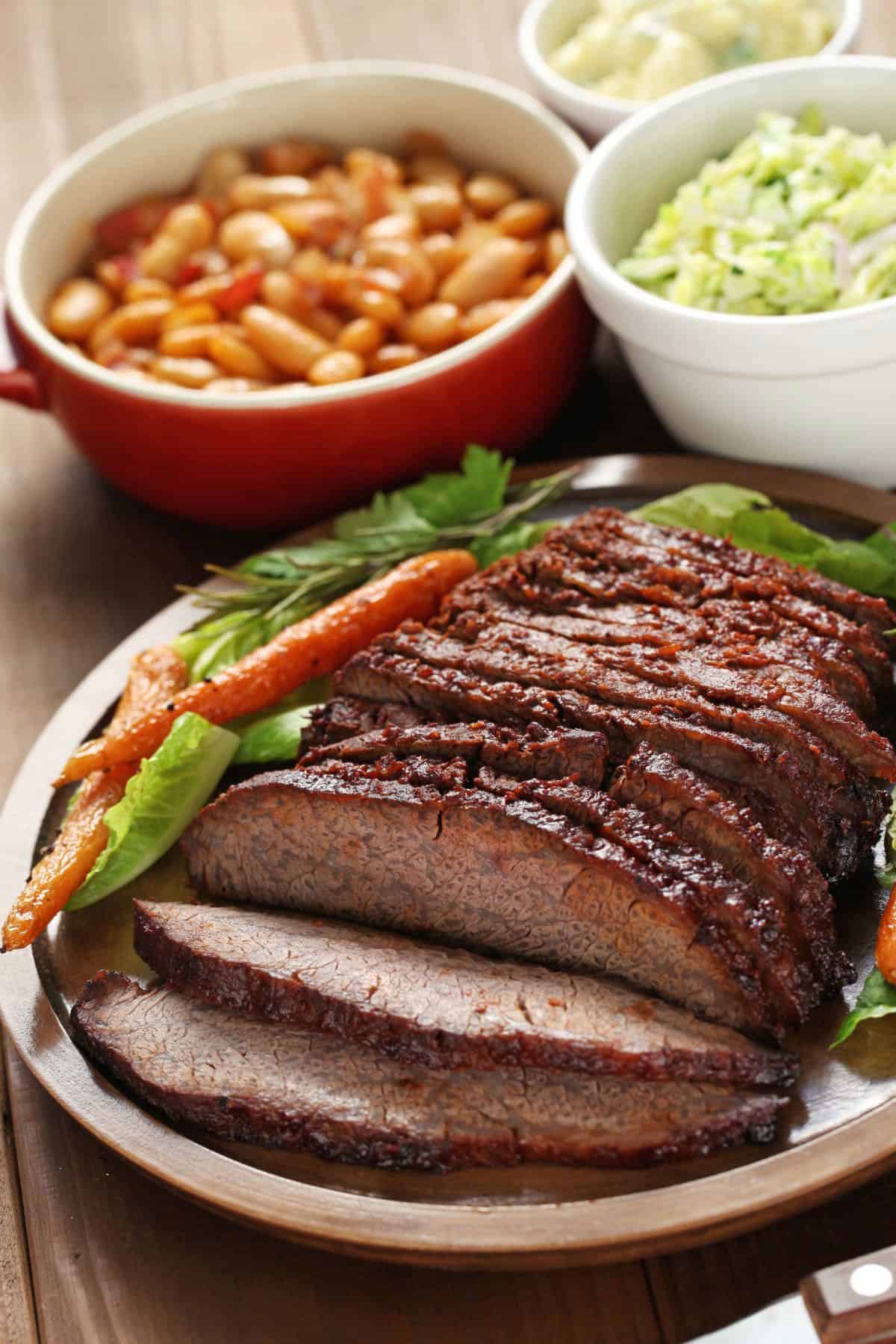 A plate of smoked beef with side dishes.