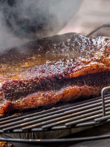 A brisket on a grill.