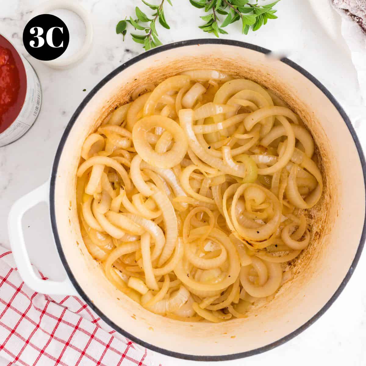 Some brown caramelized onions in a pot.