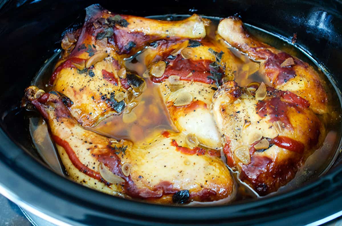 some chicken leg quarters in a crock pot,