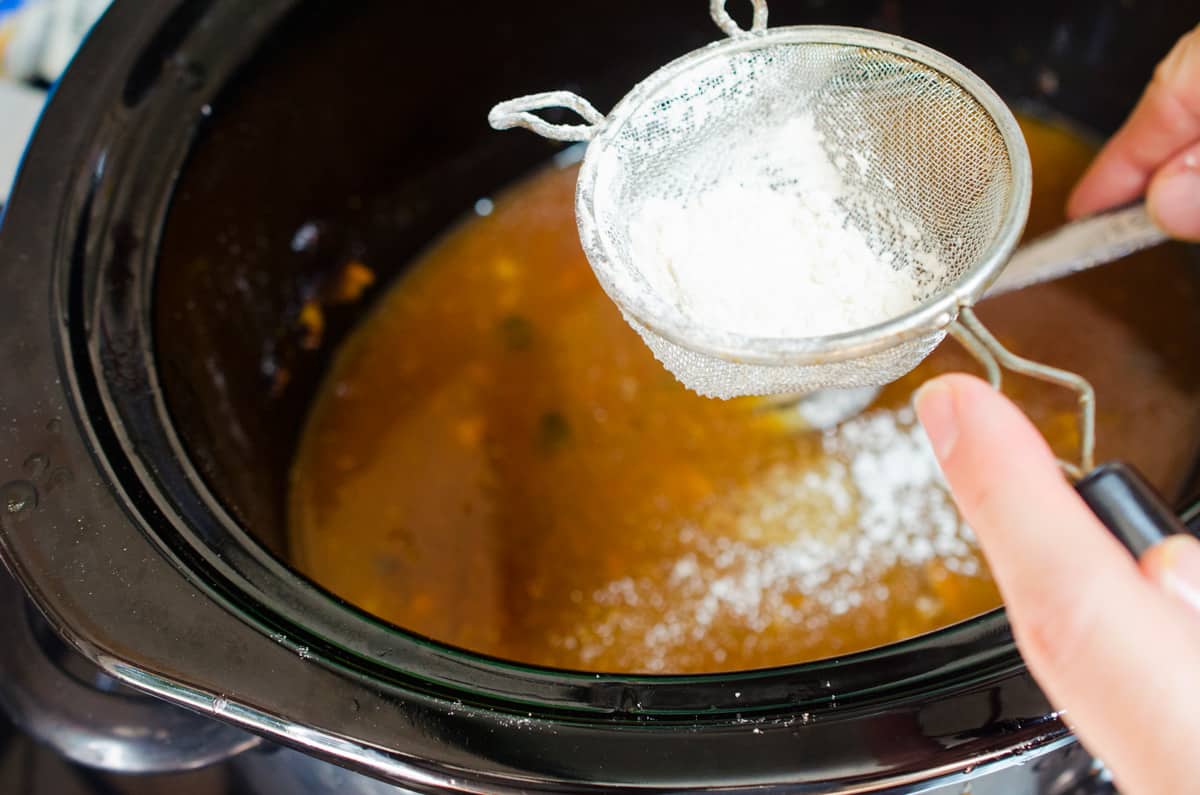 Adding flour to crock pot chicken juices.