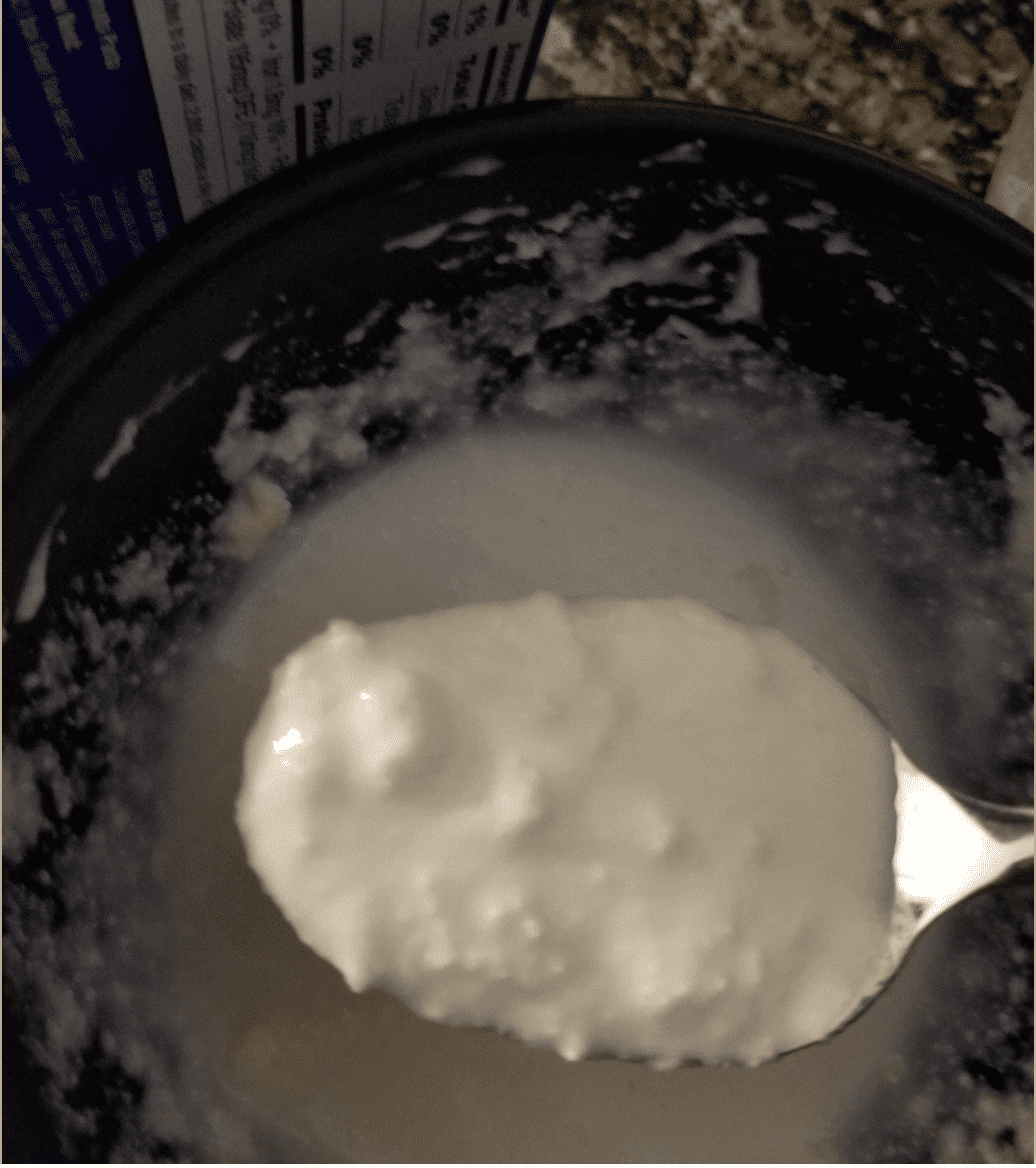 A spoonful of clumpy alfredo sauce.