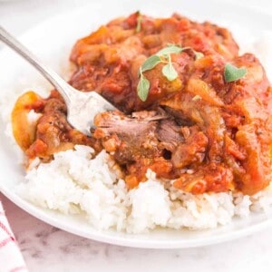 A serving of Swiss steak over white rice.