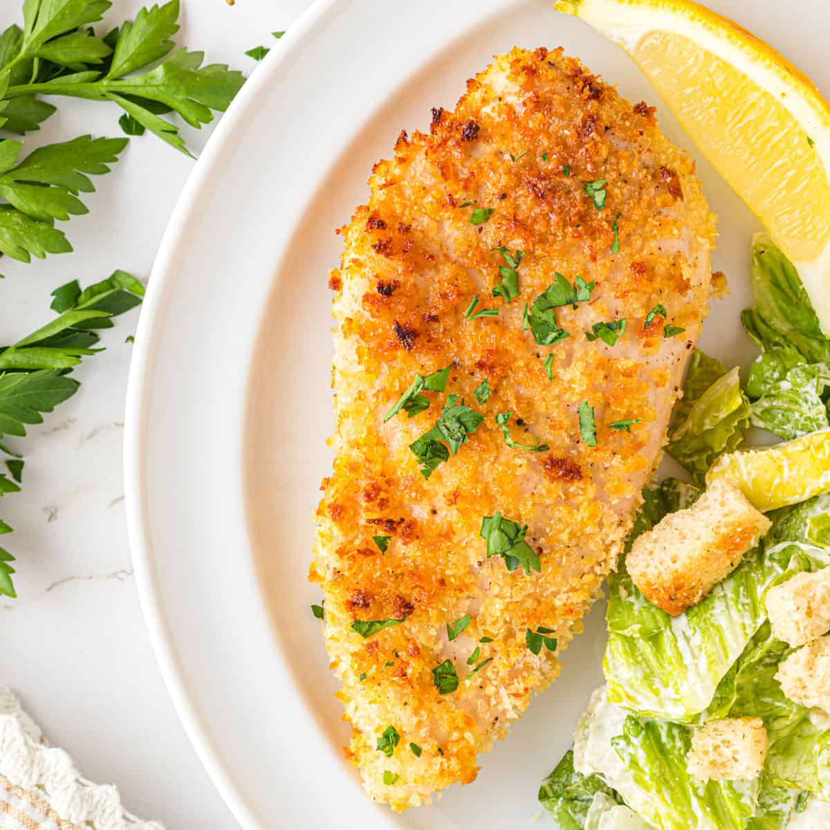 A plate of panko chicken with salad.