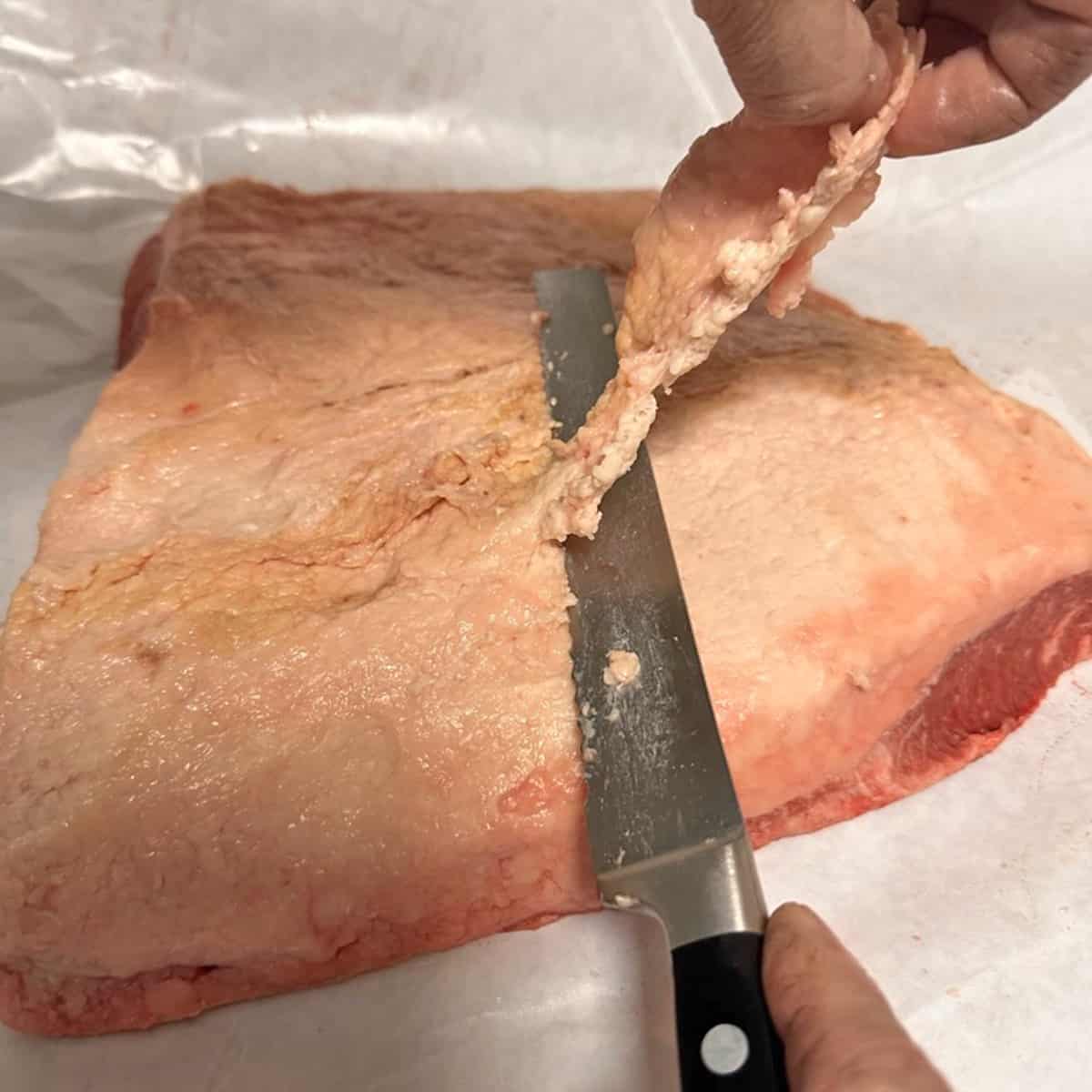 Trimming fat on a brisket flat.