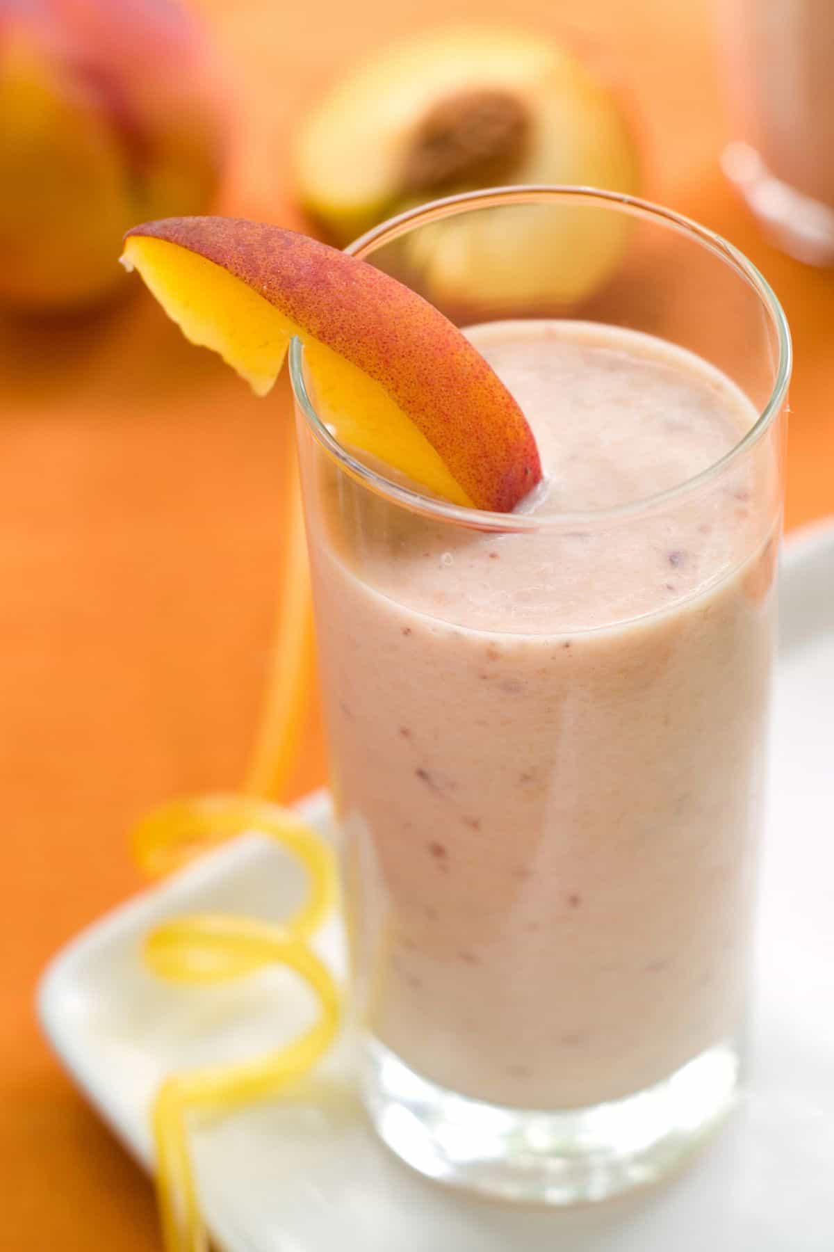 A peach smoothie in a glass.