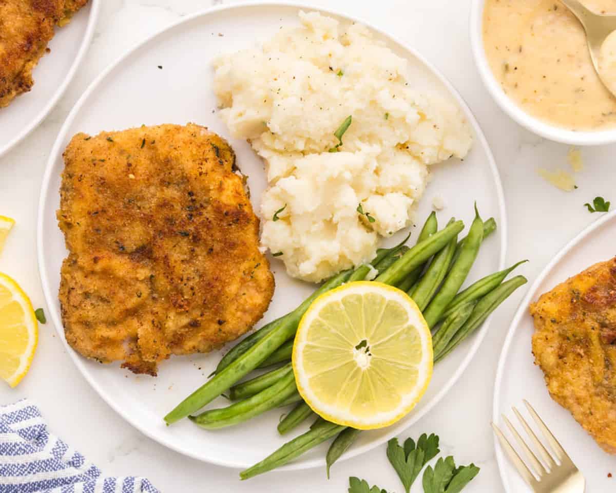 A serving of Parmesan pork, mashed potatoes, and more.