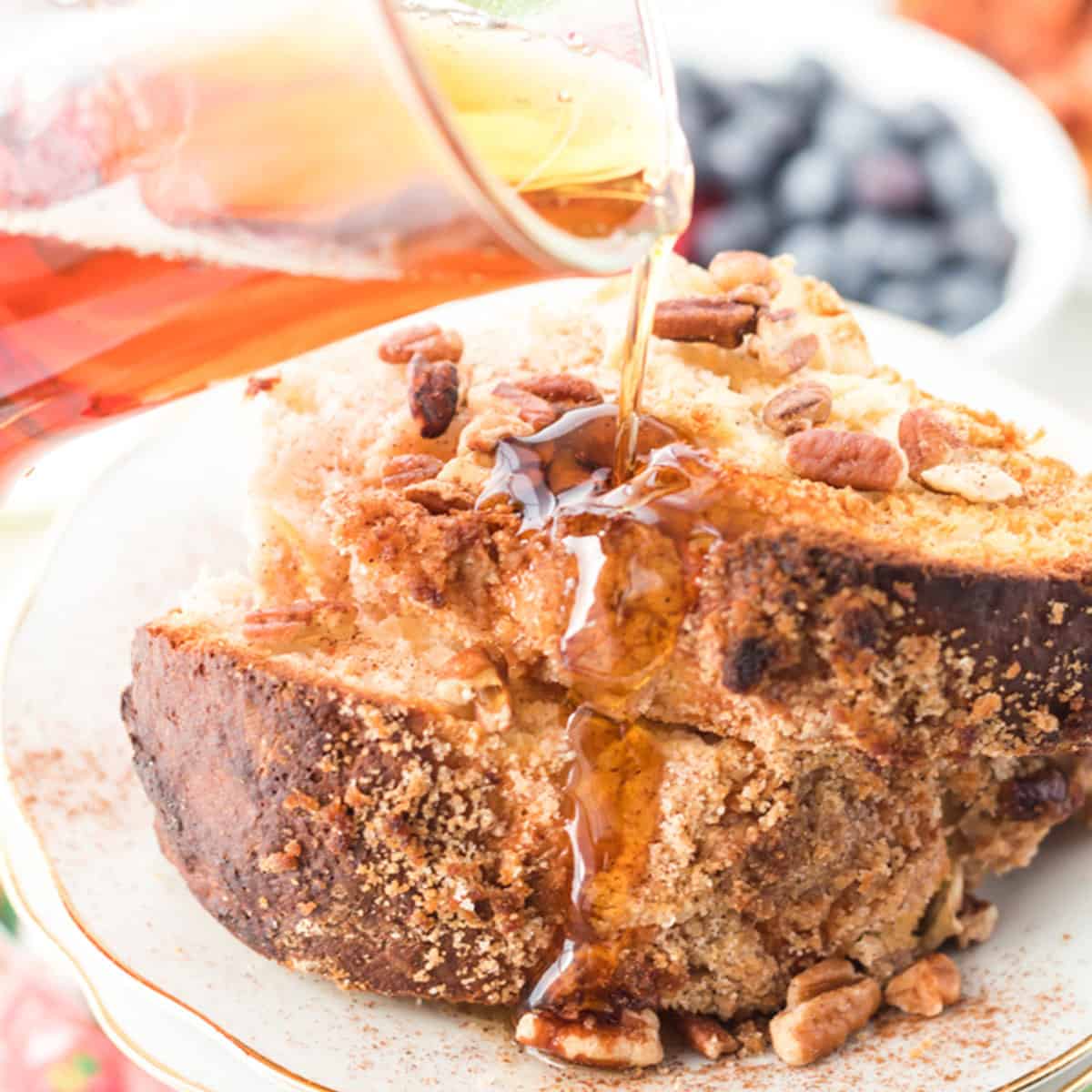 Pouring maple syrup on coffee cake.