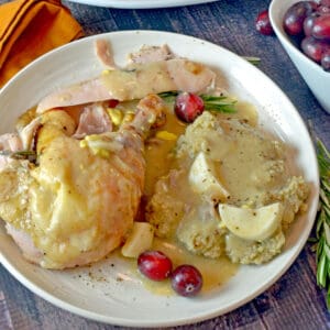A plate of turkey, mashed potatoes, and gravy.