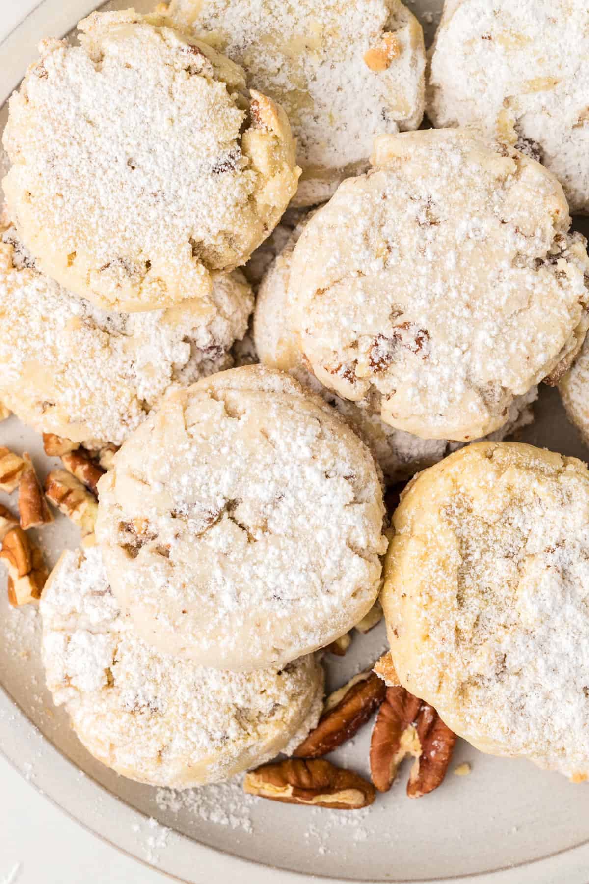 A plate of pecan sandies on a cookie tray.
