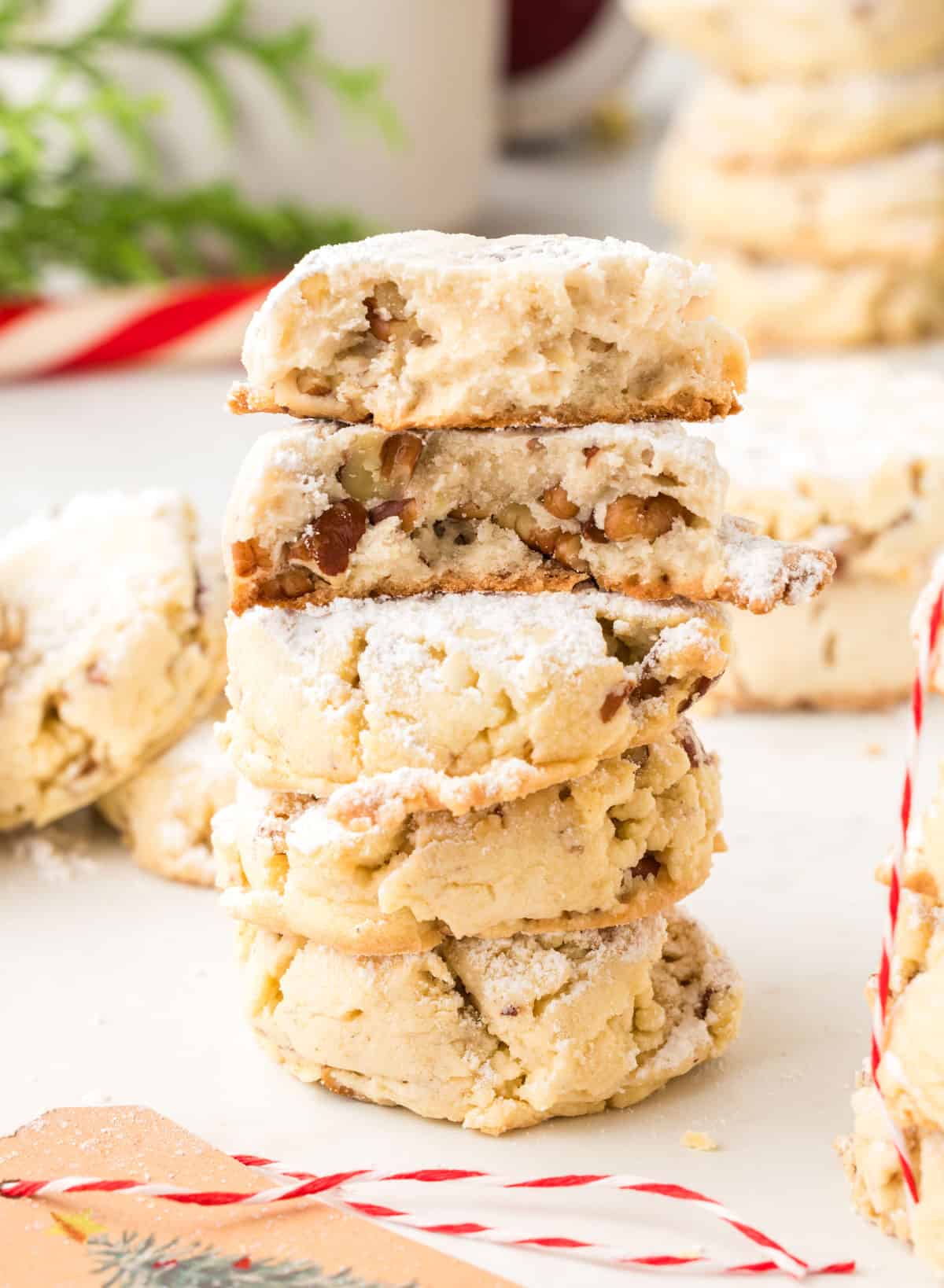 A stack of cookies with pecans in the center.