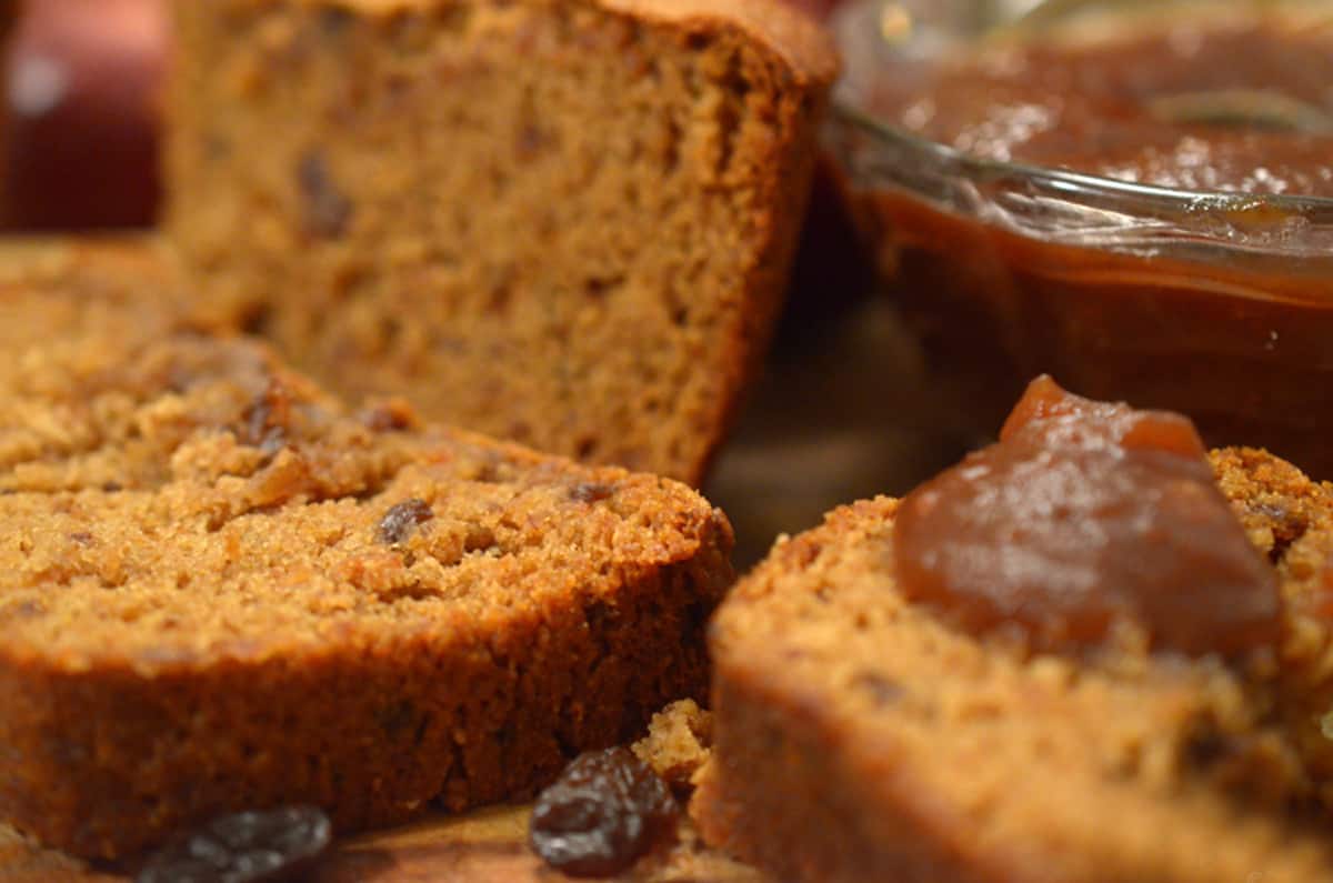 Some slices of brown bread with apple butter on them.