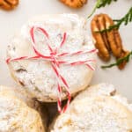A stack of cookies with a bow tied around them.