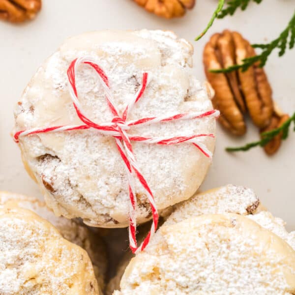 A stack of cookies with a bow tied around them.