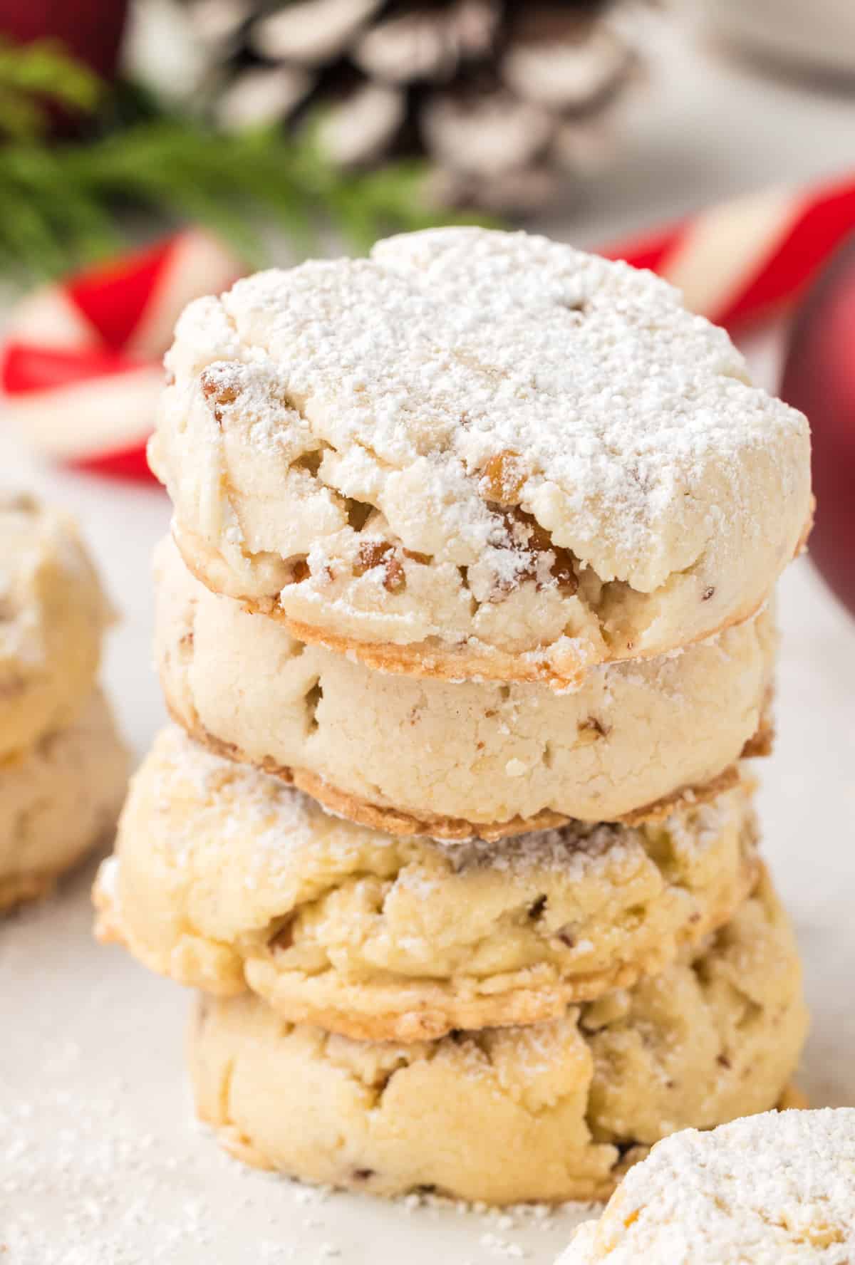 A stack of cookies with powdered sugar on them.