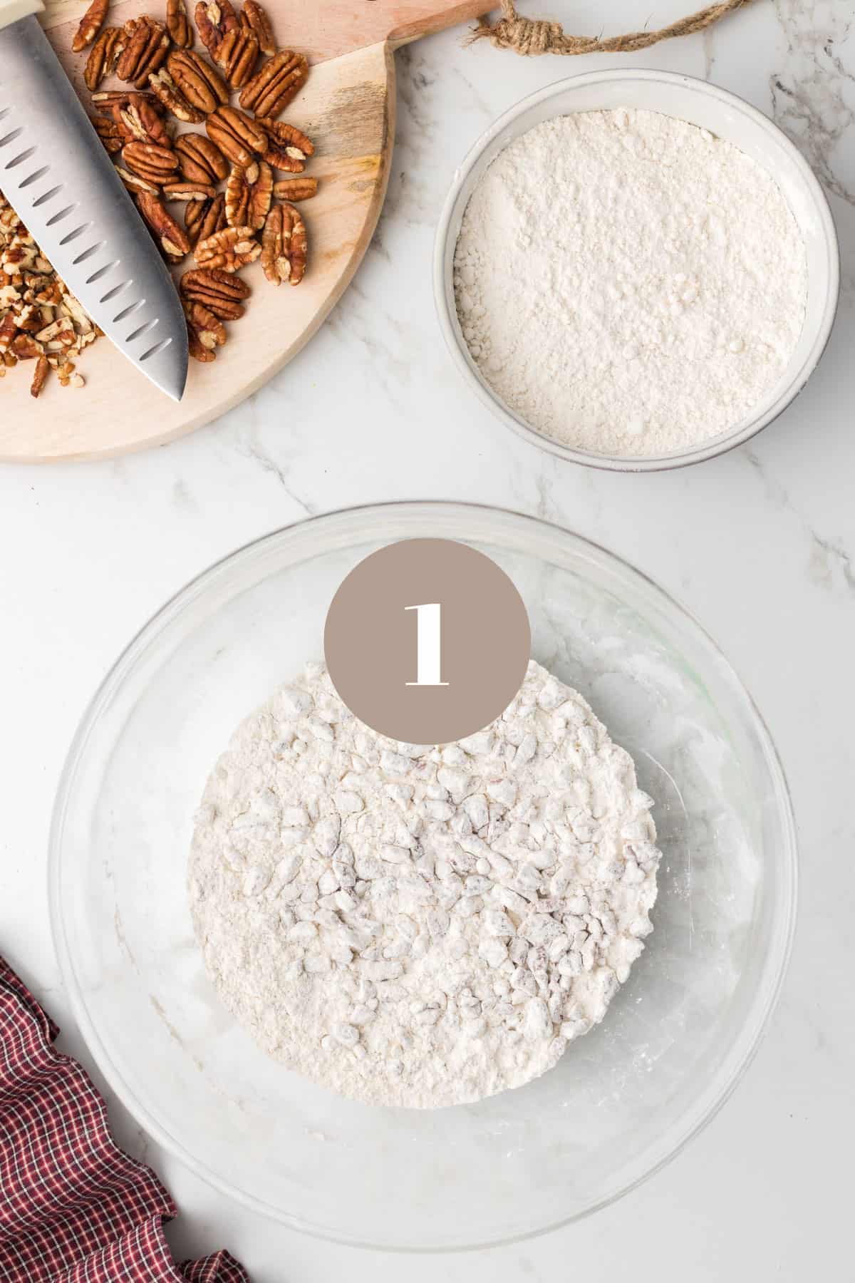 A bowl of flour and some pecans.