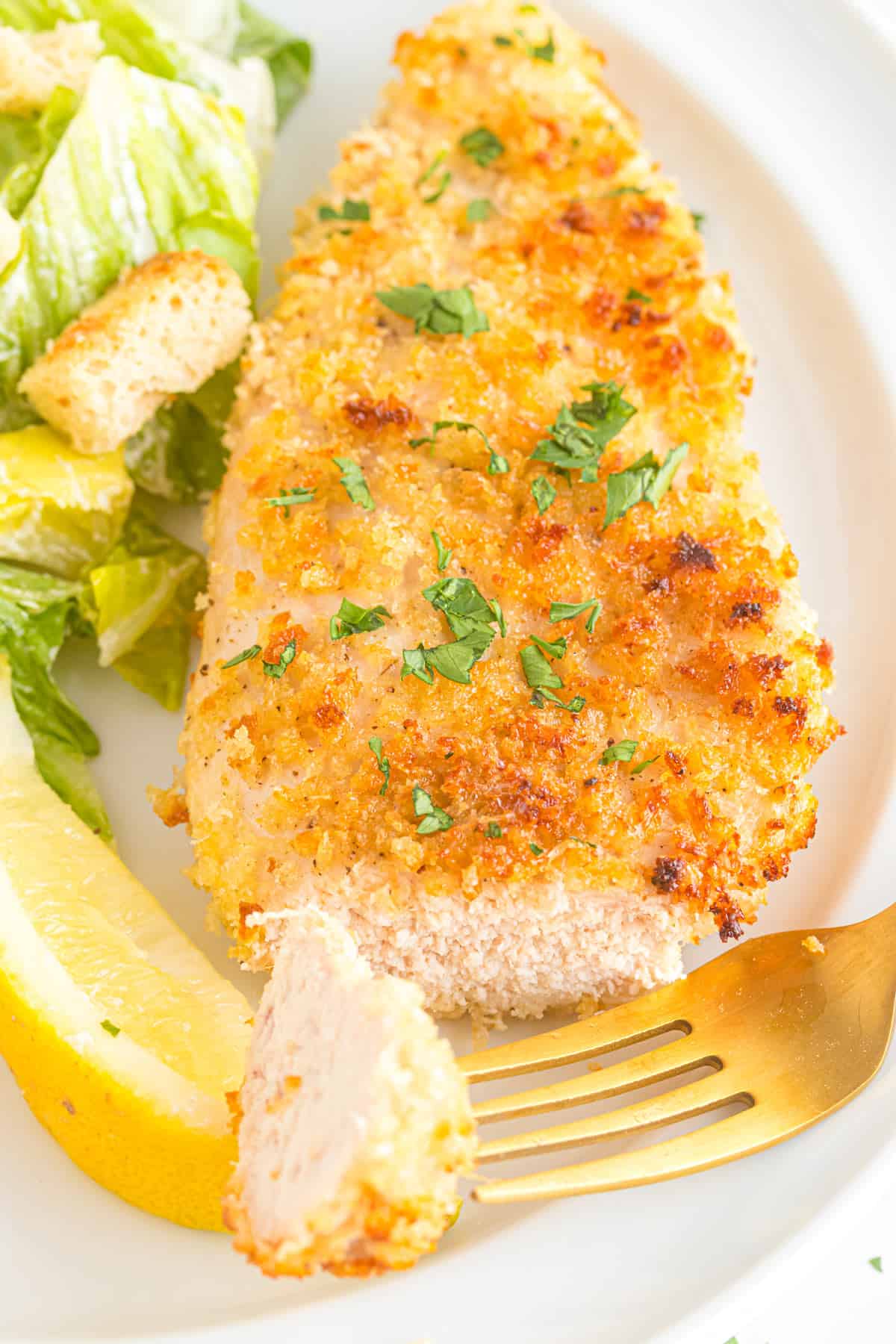 A bite of Panko chicken on a fork.