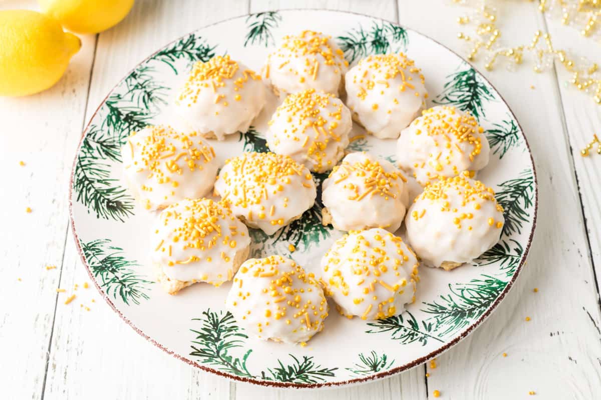 A plate of ricotta cookies with yellow sprinkles.