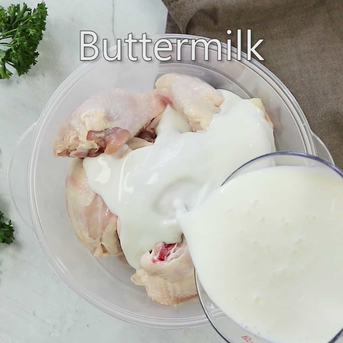 Adding buttermilk to a bowl of chicken.
