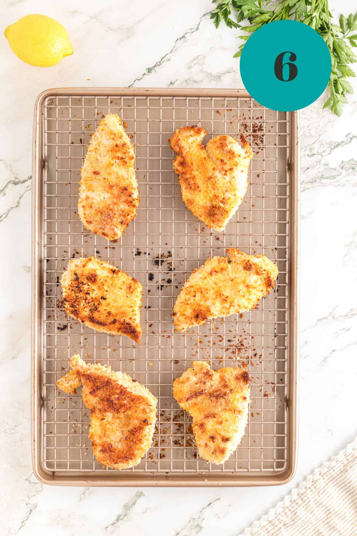 Some baked chicken on a baking rack.