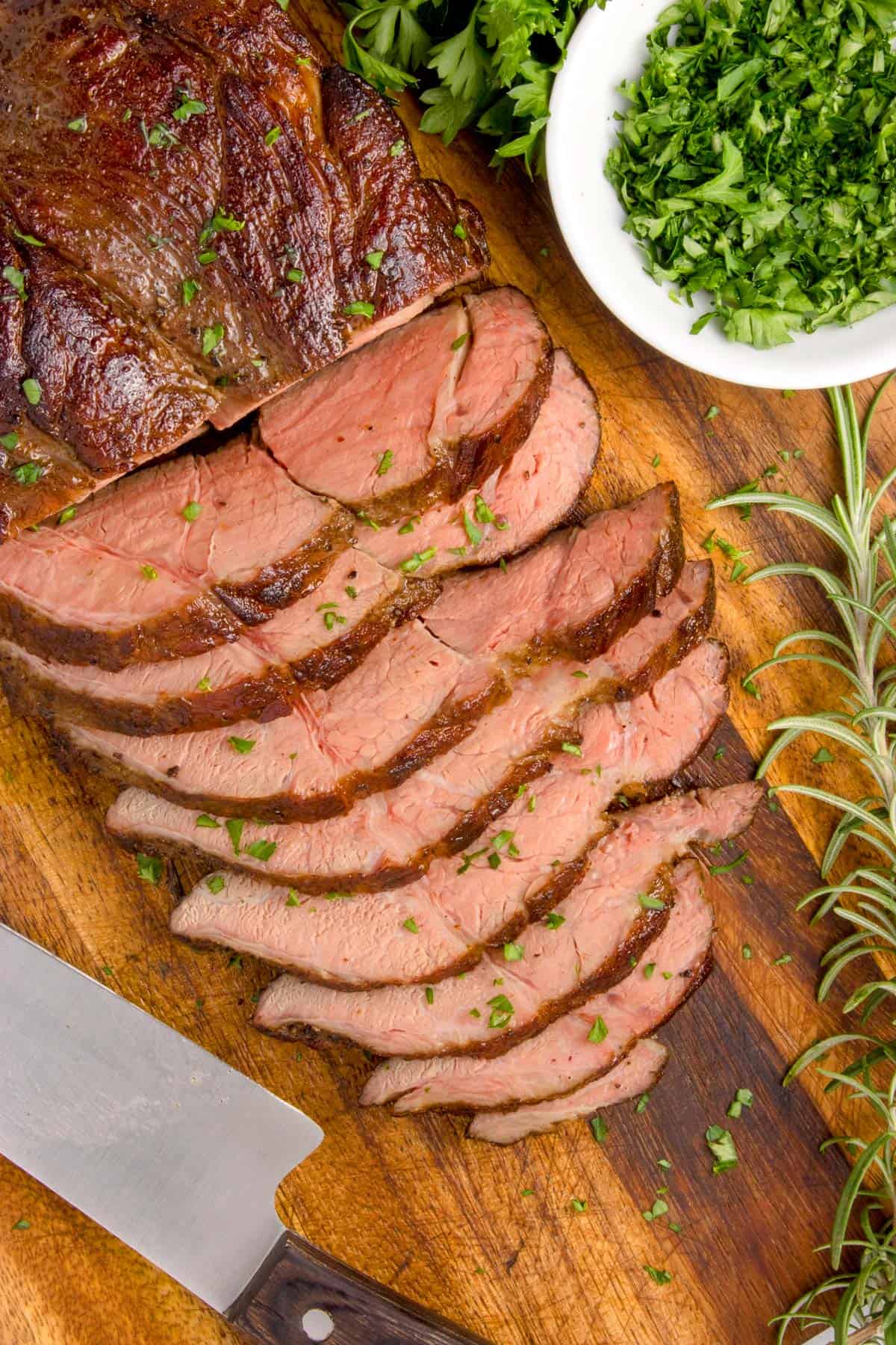 Some sliced meat on a cutting board.