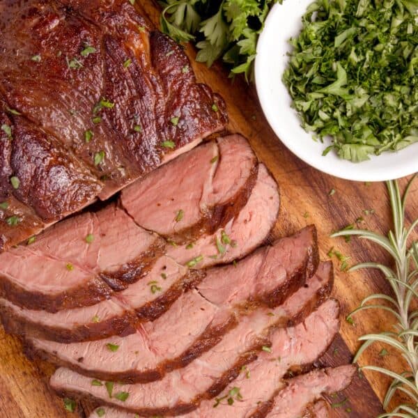 Overhead view of some sliced beef on a cutting board.